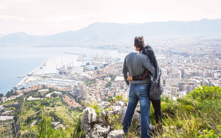 A couple enjoys the view from the top of Monte Pellegrino