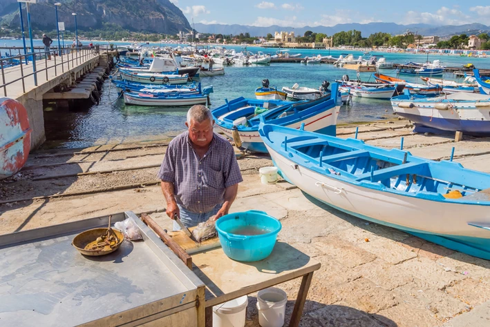 A fisherman on Palermo's Mondello beach