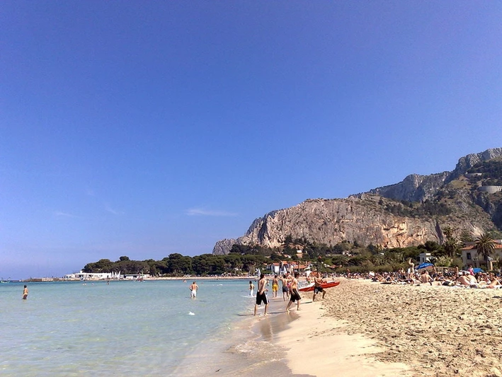 Bathers enjoy the good weather at Palermo's Mondello beach