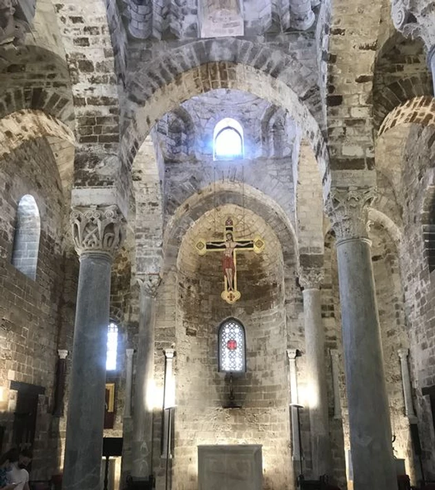 View of the white marble altar in the central nave of the church of San Cataldo.