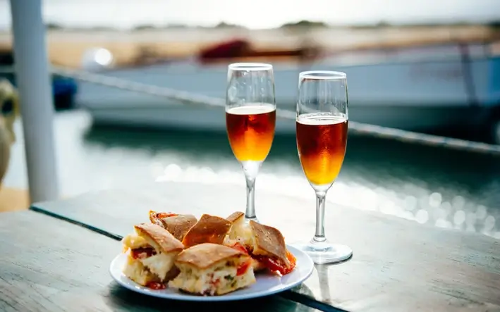 Two glasses of dessert wine with pastries