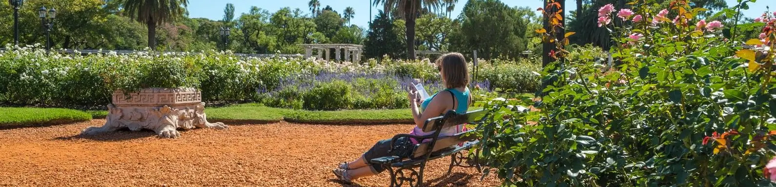 Woman sitting in the park in Palermo reading