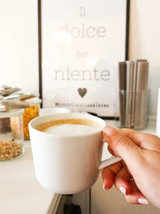 Hand holding coffee cup in the lounge
