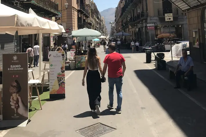 Couple strolling through the old town of Palermo