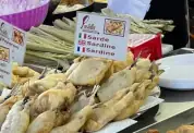 Fried sardines on a market stall