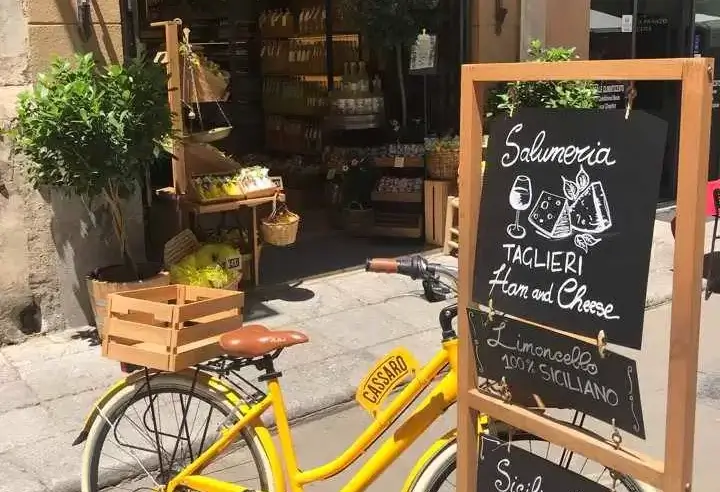 Yellow bicycle in front of a shop in the old town of Palermo