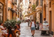 Woman walking through the alleys of the old town in Palermo