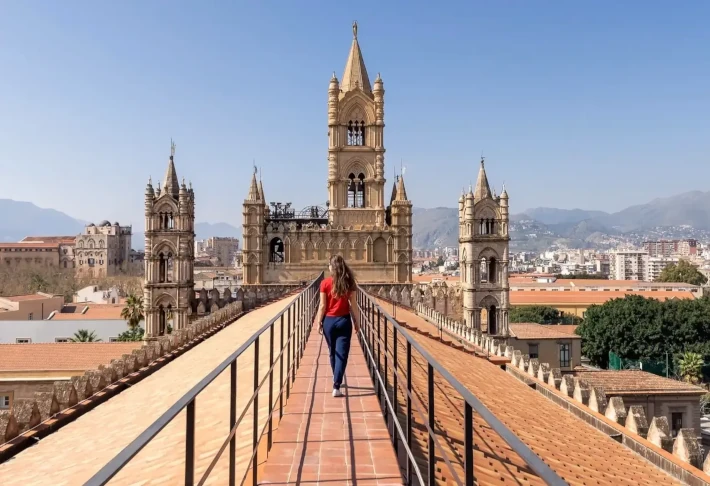 A woman walks on the roof of the cathedral in Palermo