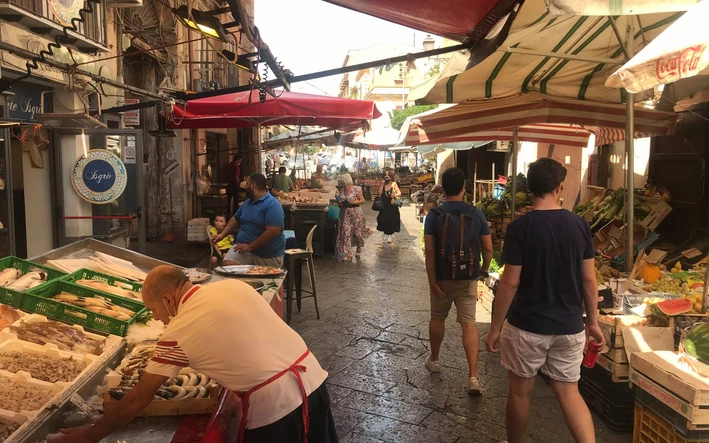 Image of pedestrians strolling through Mercato del Capo