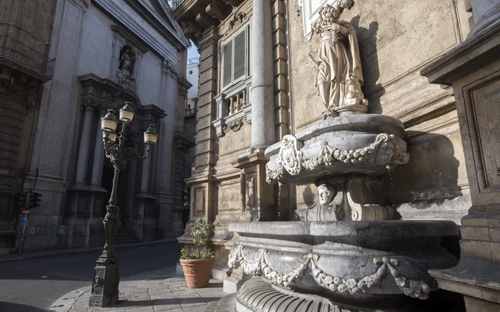 A fountain with statue at the Quattro Canti